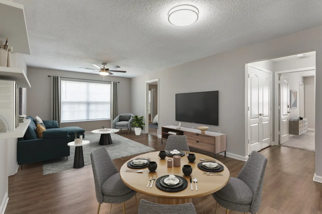 Open living and dining space with large window and ceiling fan