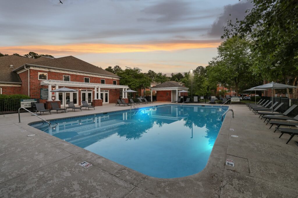 Outdoor deck with swimming pool and shaded tanning beds