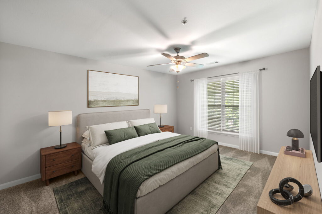 Carpeted bedroom with bed, nightstands, window, and overhead ceiling fan