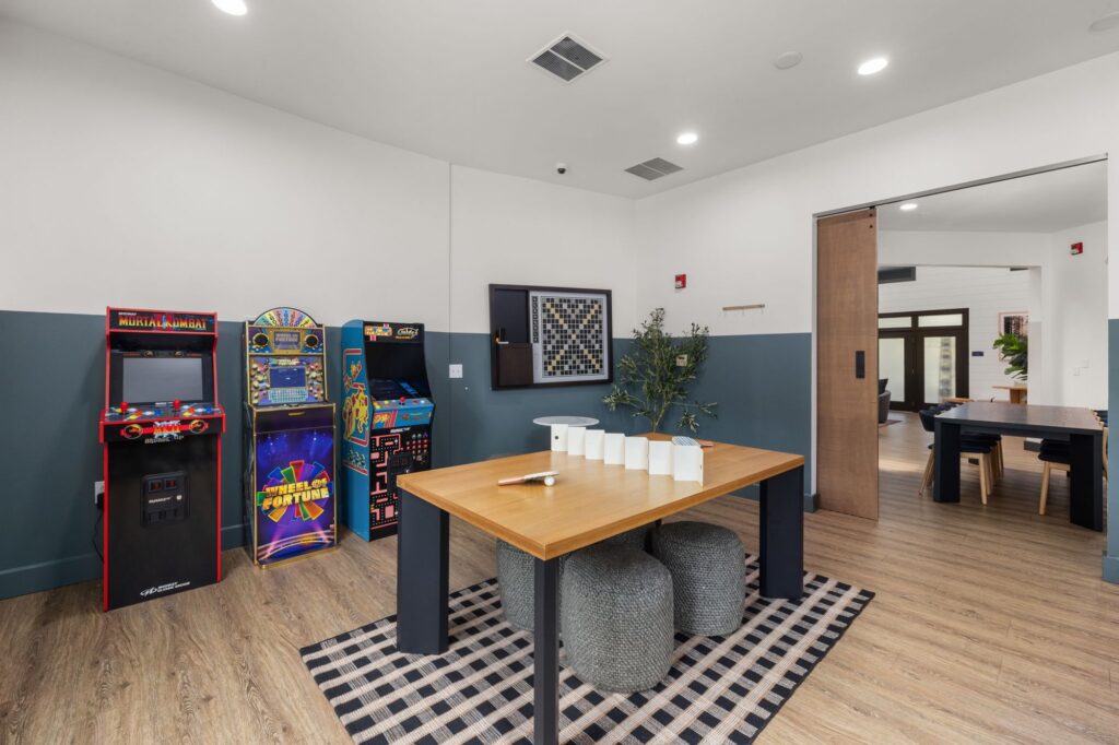 game room with arcade machines and central table with chairs