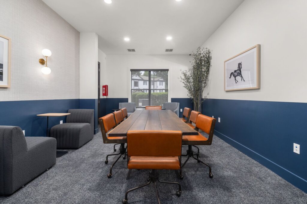 private meeting space with large conference table and chairs and lounge seating